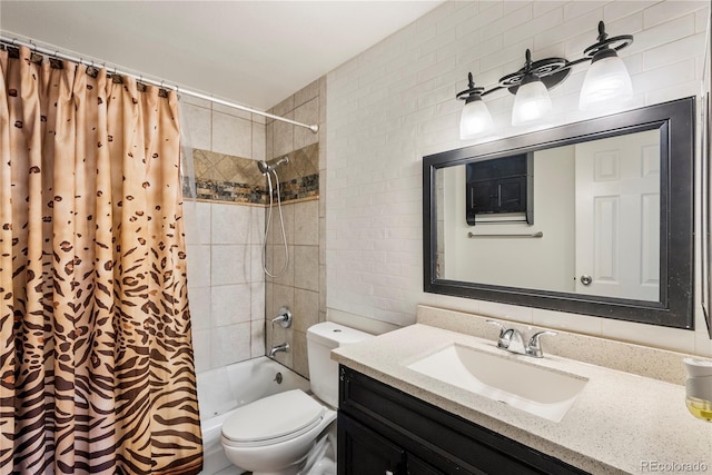 full bathroom featuring vanity, tiled shower / bath, and toilet