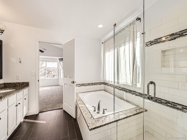 bathroom featuring vanity, wood-type flooring, and independent shower and bath