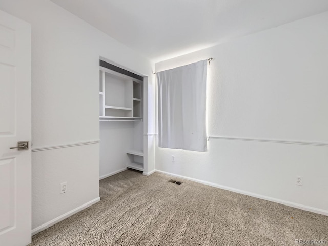 unfurnished bedroom featuring carpet floors and a closet