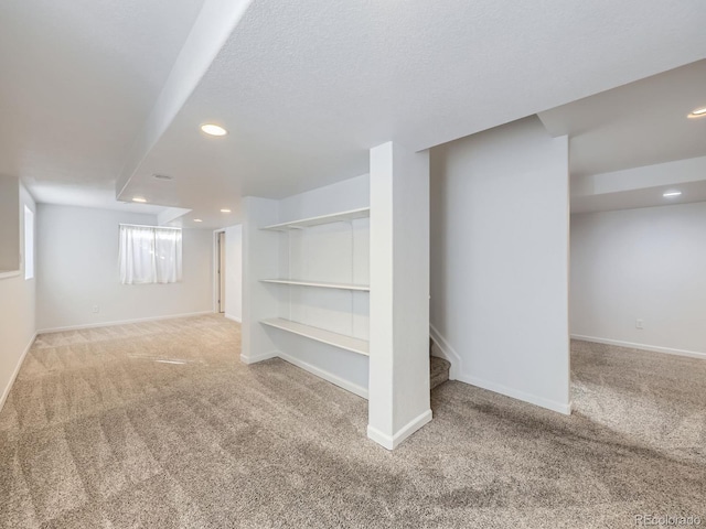 basement with carpet and a textured ceiling