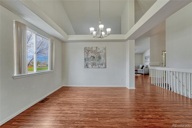 5350 S Quail Way, Littleton, CO 80127 - unfurnished dining area with wood finished floors, a chandelier, and baseboards