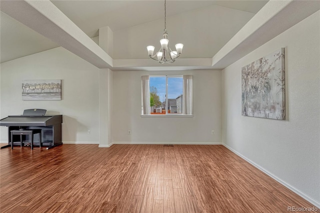 5350 S Quail Way, Littleton, CO 80127 - unfurnished dining area featuring a chandelier, wood finished floors, baseboards, a tray ceiling, and vaulted ceiling