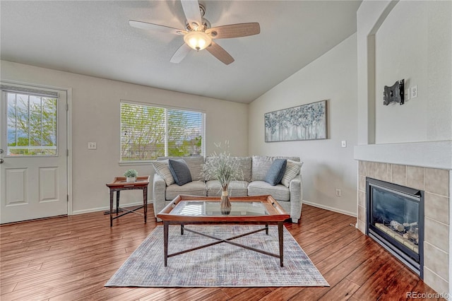 5350 S Quail Way, Littleton, CO 80127 - living area with lofted ceiling, ceiling fan, wood finished floors, a fireplace, and baseboards