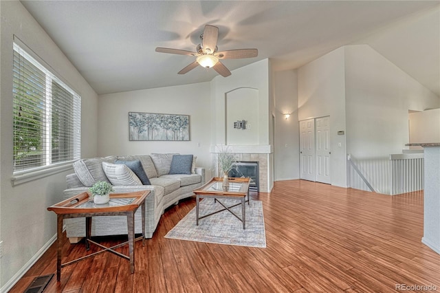 5350 S Quail Way, Littleton, CO 80127 - living room featuring vaulted ceiling, wood finished floors, ceiling fan, a tile fireplace, and baseboards