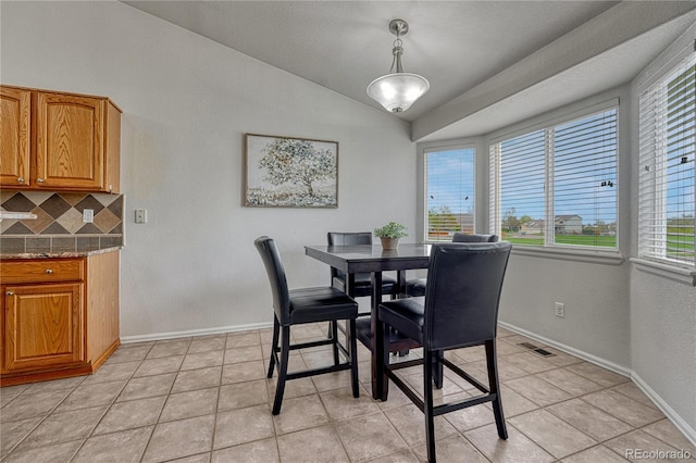 5350 S Quail Way, Littleton, CO 80127 - dining room featuring vaulted ceiling, healthy amount of natural light, baseboards, and light tile patterned floors