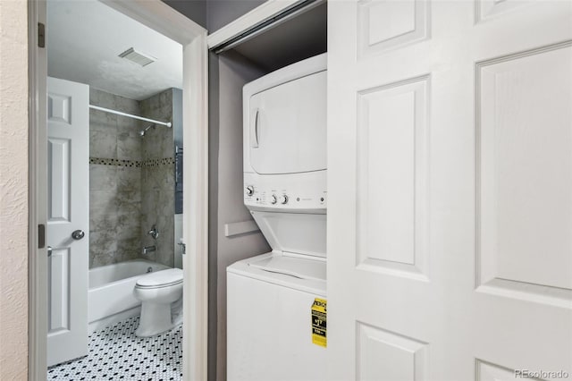 laundry area with stacked washer and dryer