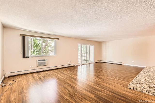 350 S Clinton St Unit 9B, Denver, CO 80247 - spare room featuring a baseboard radiator, wood finished floors, a textured ceiling, baseboard heating, and a wall mounted AC