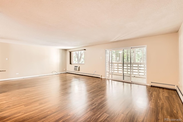 350 S Clinton St Unit 9B, Denver, CO 80247 - spare room featuring a baseboard heating unit, wood finished floors, and a textured ceiling