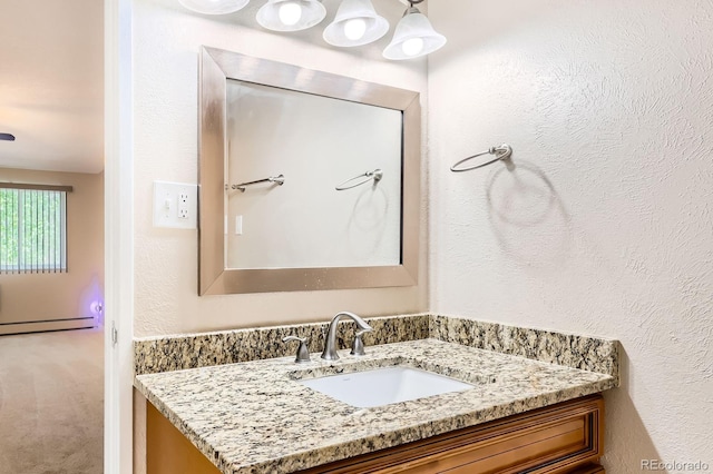 350 S Clinton St Unit 9B, Denver, CO 80247 - bathroom featuring vanity, baseboard heating, and a textured wall