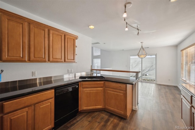 kitchen with a wealth of natural light, dishwasher, a peninsula, and a sink