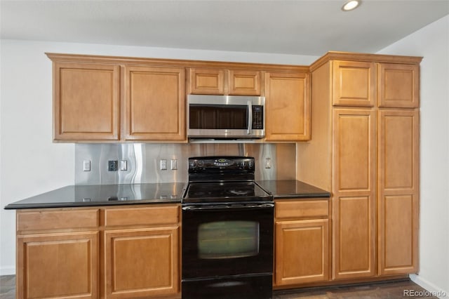 kitchen featuring black / electric stove, dark countertops, baseboards, recessed lighting, and stainless steel microwave