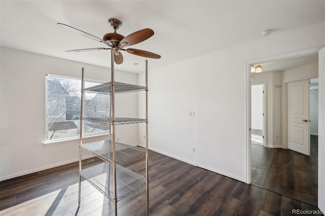 unfurnished bedroom with ceiling fan, baseboards, and wood finished floors