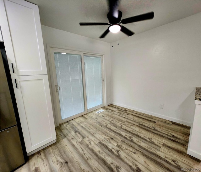16800 E Bails Pl, Aurora, CO 80017 - unfurnished bedroom with light wood-style floors, freestanding refrigerator, and ceiling fan