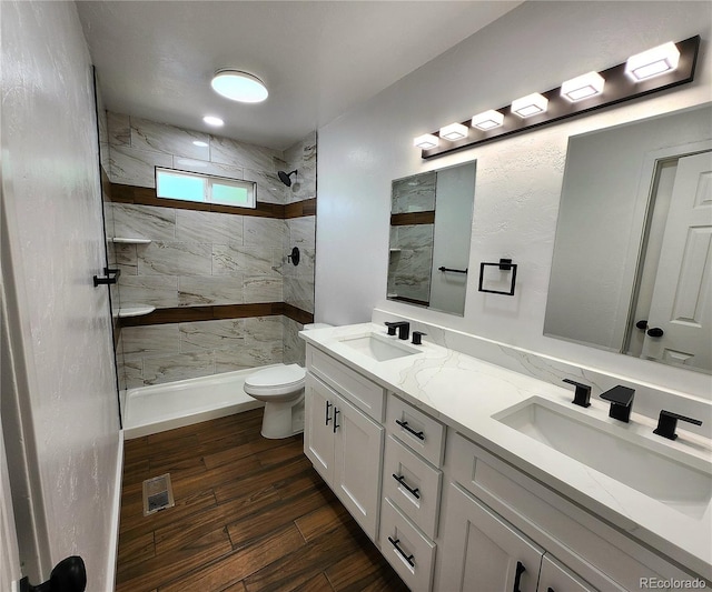 16800 E Bails Pl, Aurora, CO 80017 - full bath featuring double vanity, tiled shower, and wood finished floors