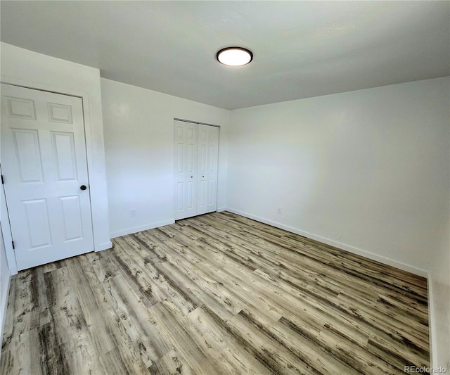 16800 E Bails Pl, Aurora, CO 80017 - unfurnished bedroom with light wood-style flooring and a closet