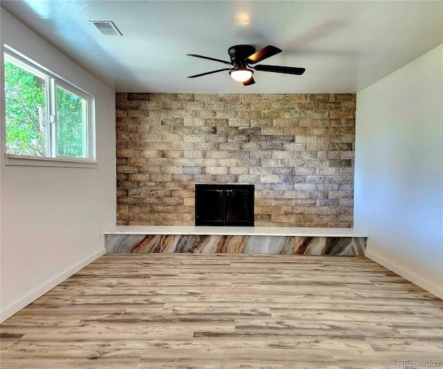 16800 E Bails Pl, Aurora, CO 80017 - unfurnished living room featuring a brick fireplace, ceiling fan, and wood finished floors