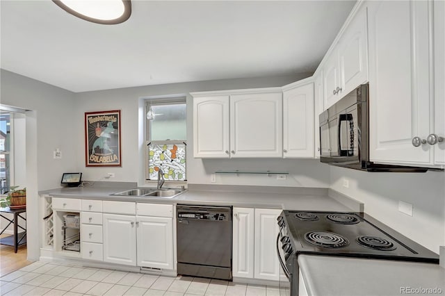 kitchen featuring white cabinets, sink, light hardwood / wood-style flooring, and black appliances