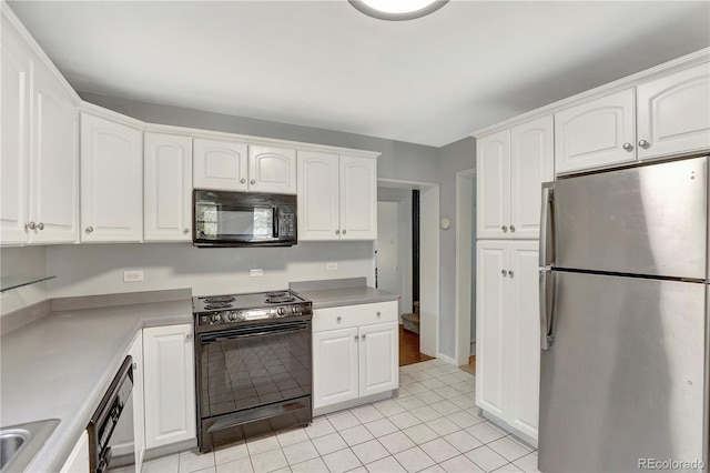 kitchen with white cabinets, black appliances, and light tile patterned floors