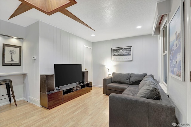 living room featuring a textured ceiling and light hardwood / wood-style flooring