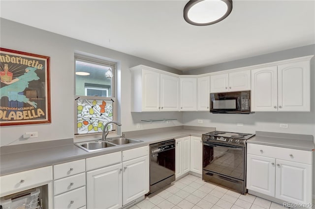 kitchen with black appliances, white cabinetry, sink, and light tile patterned floors