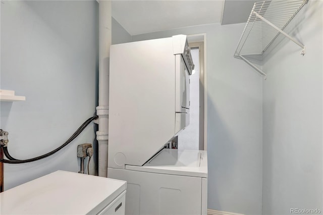 laundry area featuring stacked washing maching and dryer