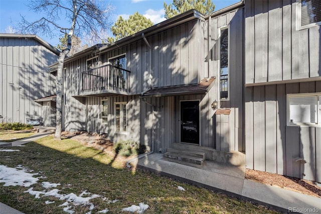 exterior space featuring a balcony, board and batten siding, and entry steps