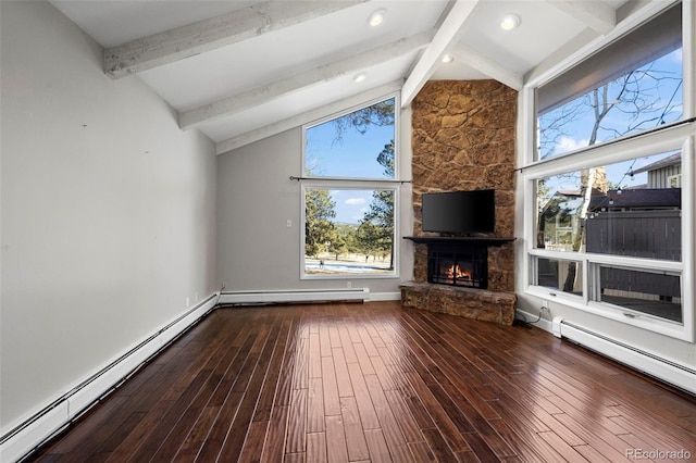 unfurnished living room with a stone fireplace, beam ceiling, wood finished floors, and baseboard heating