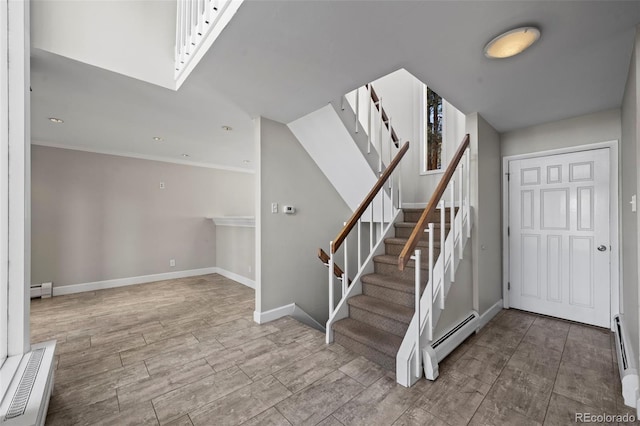 stairs featuring crown molding, wood finished floors, baseboards, and a baseboard radiator