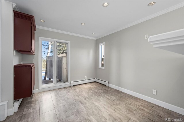 spare room featuring a baseboard heating unit, recessed lighting, baseboards, and ornamental molding