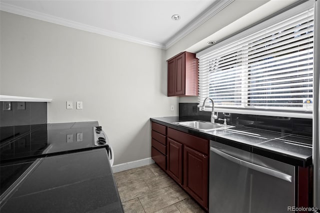 kitchen with dark countertops, a sink, crown molding, baseboards, and stainless steel dishwasher