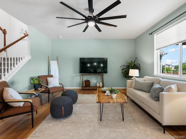 800 Boulder Peak Ave, Erie, CO 80516 - living area featuring wood finished floors, a ceiling fan, and stairway