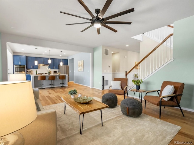 800 Boulder Peak Ave, Erie, CO 80516 - living area with light wood finished floors, stairway, and a ceiling fan
