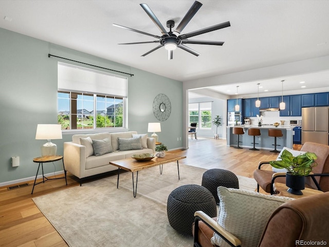 800 Boulder Peak Ave, Erie, CO 80516 - living room featuring light wood-style flooring, ceiling fan, and recessed lighting