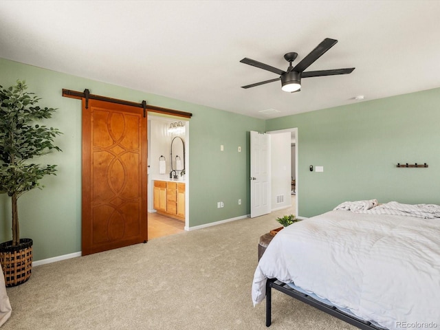 800 Boulder Peak Ave, Erie, CO 80516 - bedroom with light carpet, ensuite bath, ceiling fan, and a barn door