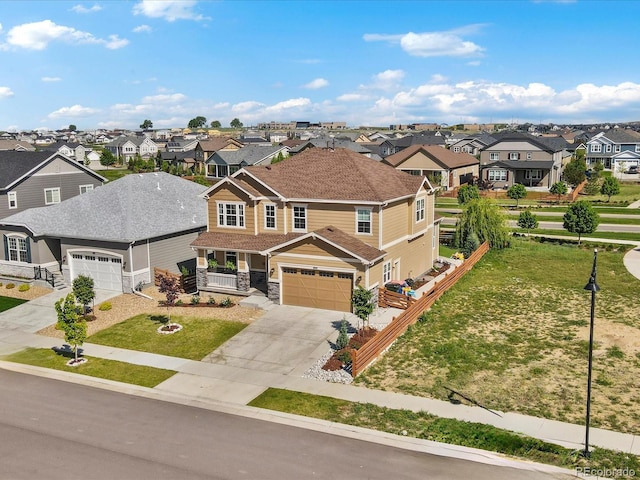 800 Boulder Peak Ave, Erie, CO 80516 - view of front of home featuring a residential view, concrete driveway, a front lawn, and stone siding