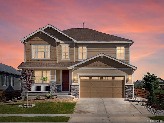 800 Boulder Peak Ave, Erie, CO 80516 - view of front of home featuring a porch, driveway, stone siding, and roof with shingles