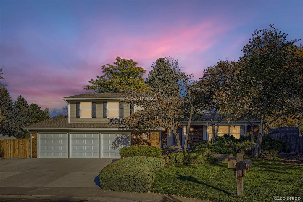 front facade featuring a yard and a garage