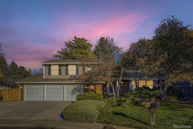 front facade featuring a yard and a garage