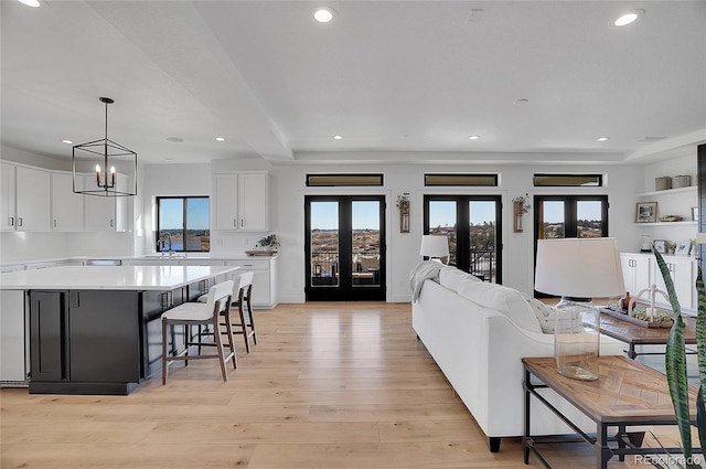 8700 Lost Lake Dr, Franktown, CO 80116 - living area featuring recessed lighting, french doors, an inviting chandelier, and light wood-style floors