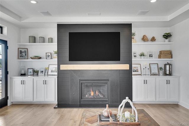 8700 Lost Lake Dr, Franktown, CO 80116 - living area with light wood finished floors, visible vents, a large fireplace, and recessed lighting