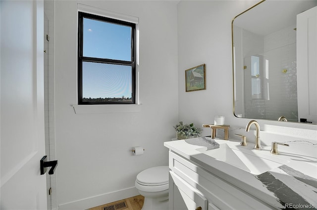 8700 Lost Lake Dr, Franktown, CO 80116 - bathroom featuring visible vents, toilet, vanity, baseboards, and walk in shower