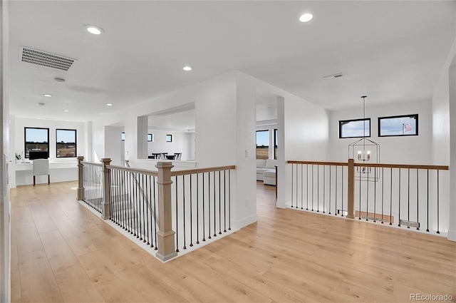 8700 Lost Lake Dr, Franktown, CO 80116 - hallway with light wood-type flooring, visible vents, recessed lighting, an upstairs landing, and a notable chandelier