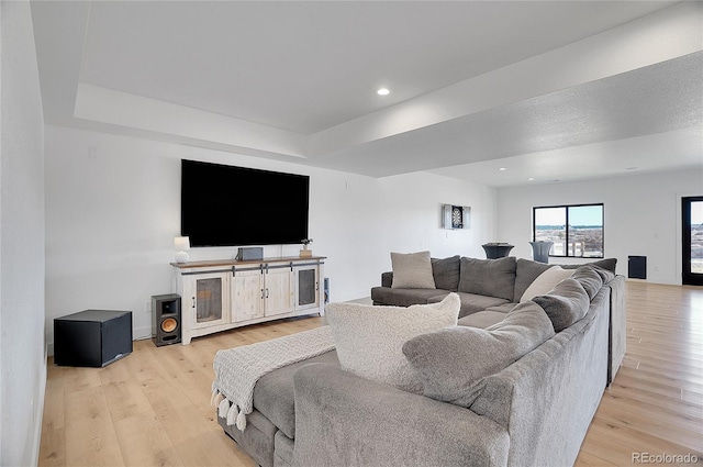 8700 Lost Lake Dr, Franktown, CO 80116 - living room with baseboards, recessed lighting, a tray ceiling, and light wood-style floors