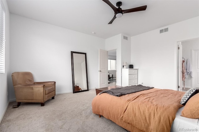 bedroom featuring light carpet, baseboards, and ceiling fan