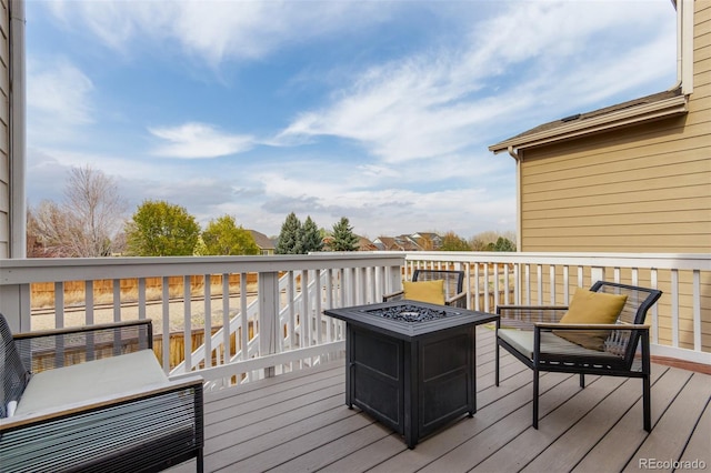 wooden deck with an outdoor fire pit