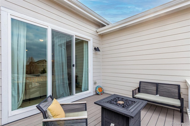wooden deck featuring an outdoor fire pit