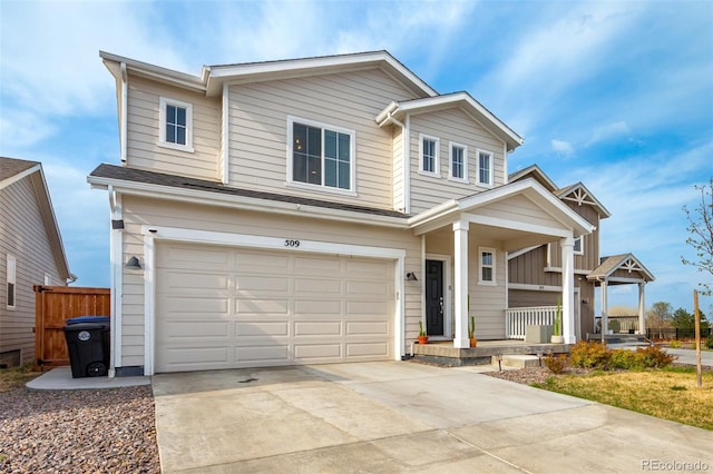 view of front of home featuring covered porch, an attached garage, driveway, and fence