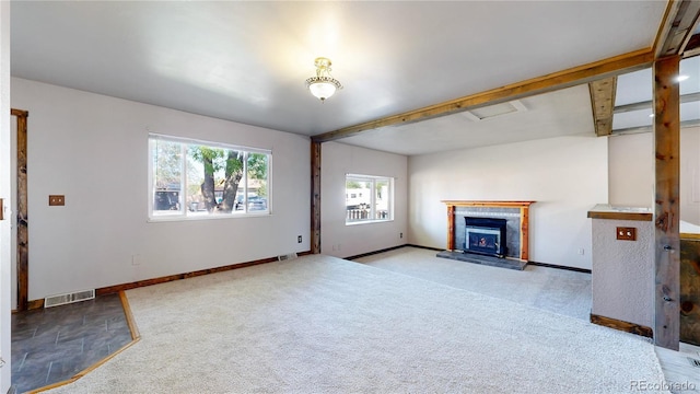 321 Stockton Ct, Gilcrest, CO 80623 - unfurnished living room with a tiled fireplace, carpet floors, and baseboards