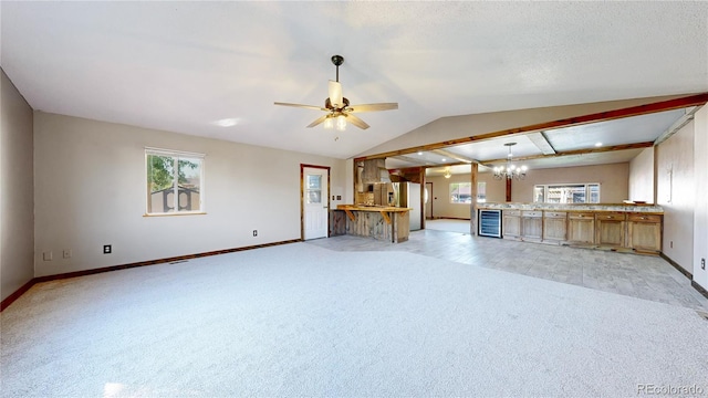 321 Stockton Ct, Gilcrest, CO 80623 - unfurnished living room with light carpet, wine cooler, baseboards, lofted ceiling, and a chandelier