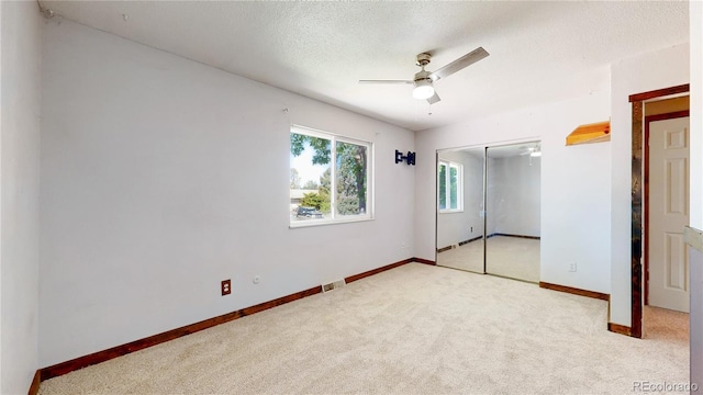 321 Stockton Ct, Gilcrest, CO 80623 - unfurnished bedroom with carpet flooring, a closet, baseboards, a textured ceiling, and ceiling fan